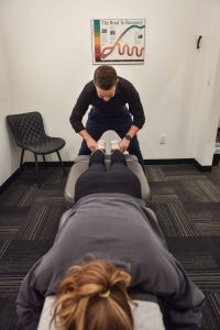 Dr. Carson Penner with Patient | Complete Health | Chiropractic & Wellness Clinic | Okotoks & SW Calgary