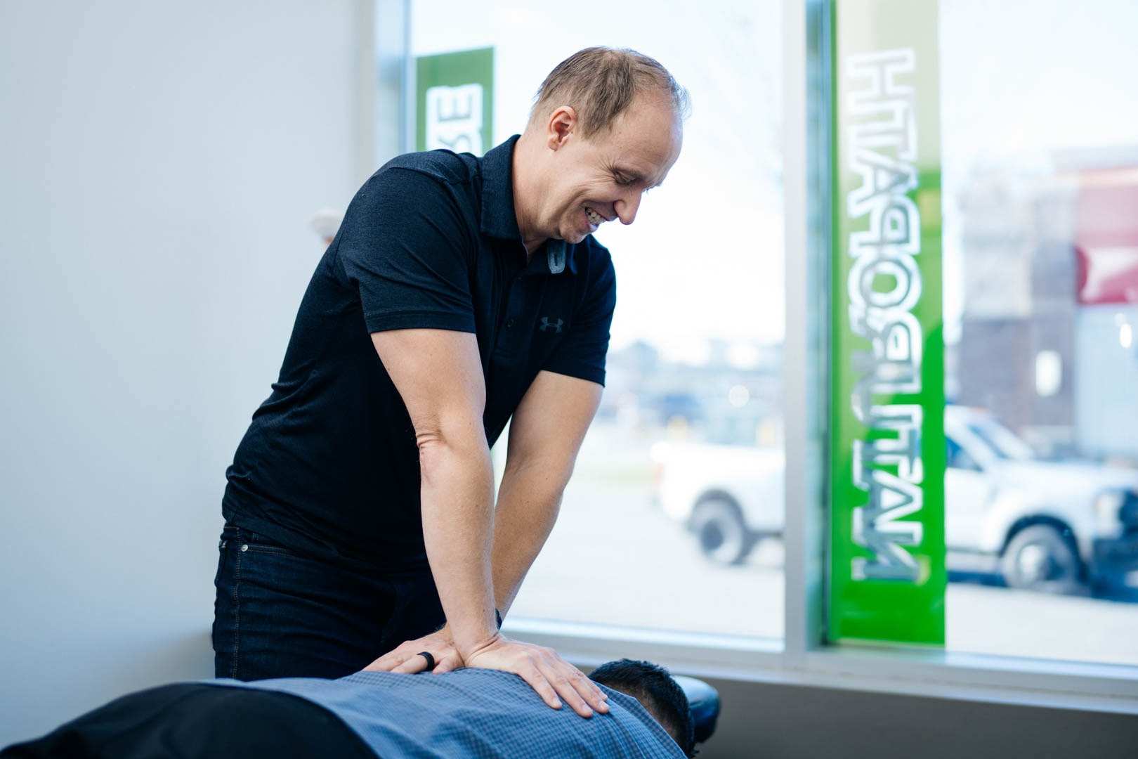 Dr. Chris Yavis with Patient | Complete Health | Chiropractic & Wellness Clinic | Okotoks & SW Calgary