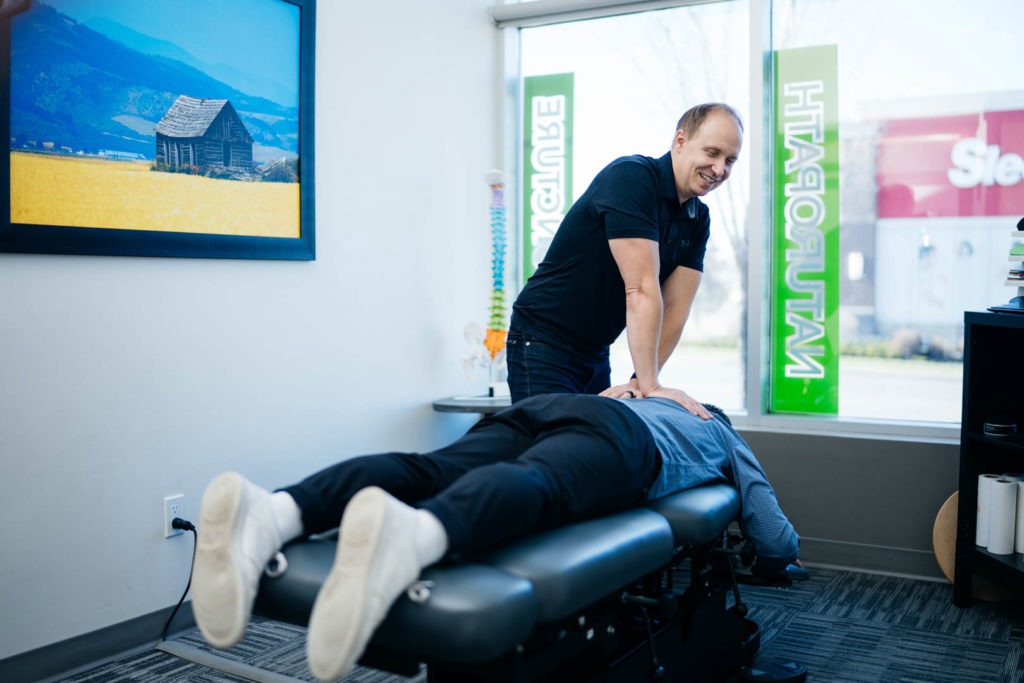 Dr. Chris Yavis with Patient | Complete Health | Chiropractic & Wellness Clinic | Okotoks & SW Calgary